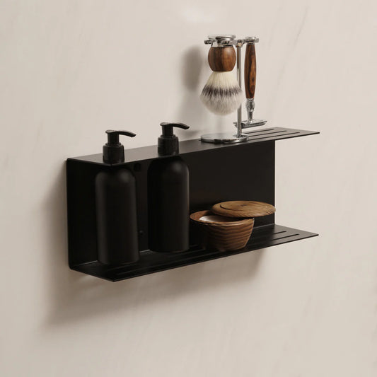 Dispensador de jabón de pared Catania en negro mate instalado en un baño minimalista