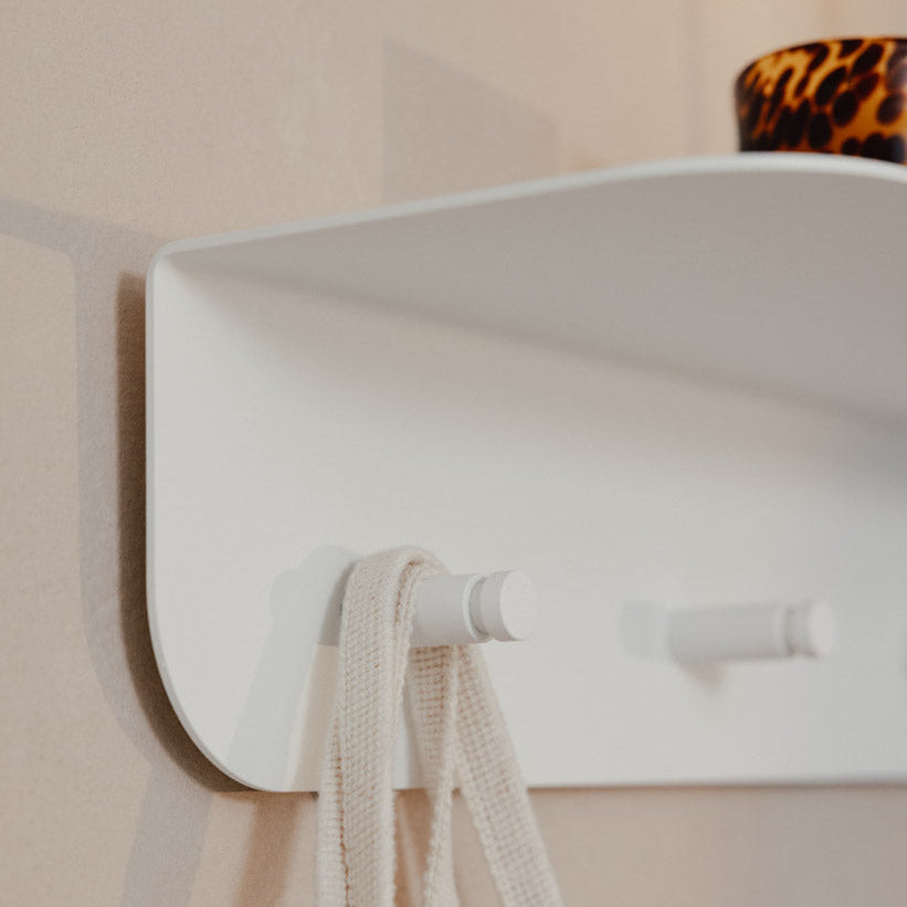 Detalle ganchos perchero de pared Milano blanco con chaqueta y llavero recibidor minimalista - Kaimok Design